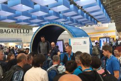The fair magician attracts huge crowds to the stand with his fair entertainment.