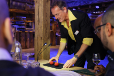 The magician at the company party captivates the audience with his impressive magic tricks